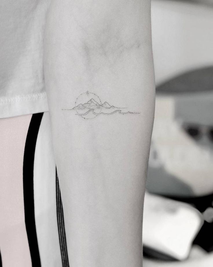 a person with a small tattoo on their arm