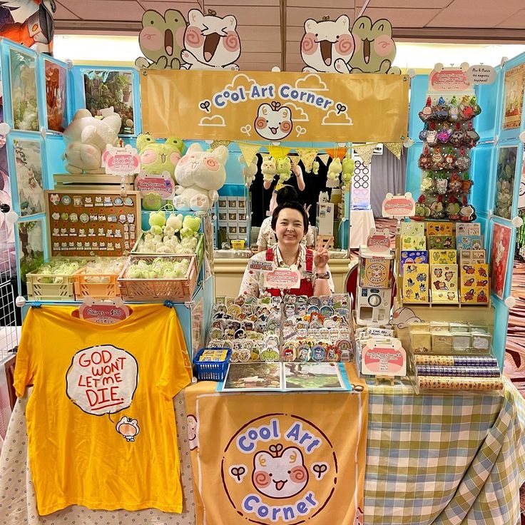 a woman standing in front of a booth selling goods