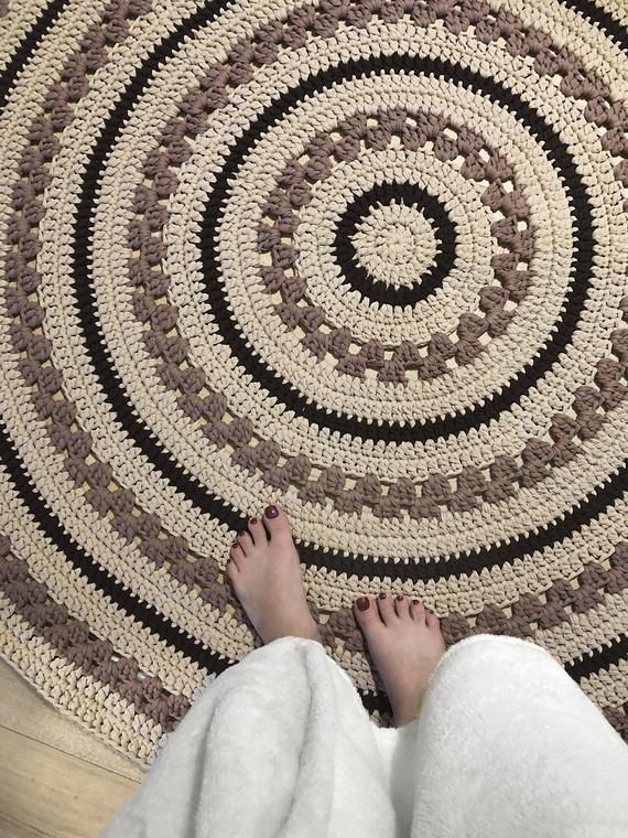 a person standing in front of a rug on the floor