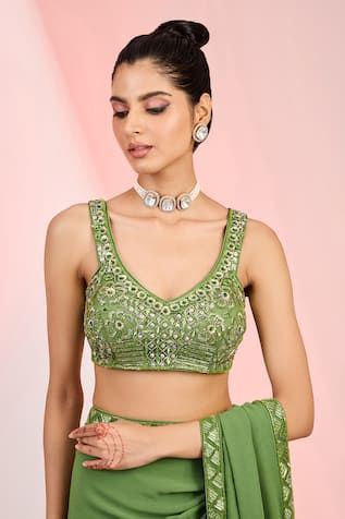 Mehendi green saree crafted in georgette base, embellished with sequin, cutdana and bead work on the hem. Paired with a bead, sequin and cutdana embellished, padded blouse. - Aza Fashions Green Sleeveless Pre-draped Saree For Festive Season, Sleeveless Green Choli With Mirror Work, Green Blouse With Sheer Dupatta For Navratri, Green Sequined Sharara, Pista Green Georgette Blouse For Party, Party Blouse In Pista Green Georgette, Pista Green Embellished Saree For Diwali, Pista Green Embellished Pre-draped Saree For Diwali, Green Embellished Anarkali Pre-draped Saree