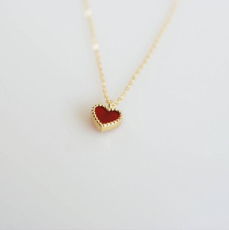 Tiny and dainty red agate heart filled with love and passion, such a perfect present for Valentine's Day and your loved ones. :: Style name: RDHRT-ENLN1034 :: Heart size: 7x7.5mm :: Material: 14k solid yellow gold :: Stone type: red agate Notes :: Jewelries are measured in millimeters and centimeters. :: Please read store policy before placing order. :: In stock items are ready to ship in 3 business days, made to order items are ready to ship in 2-4 weeks. :: International Shipping AVAILABLE. :: Minimalist Red Heart-shaped Jewelry, Red Heart Charm Fine Jewelry, Red Heart-shaped Jewelry For Mother's Day, Red Fine Jewelry With Heart Charm, Red Open Heart Jewelry For Mother's Day, Red 14k Gold Jewelry For Valentine's Day, Red 14k Gold Heart Cut Jewelry, 14k Gold Heart Cut Red Jewelry, Red Heart Pendant Jewelry As Gift For Her