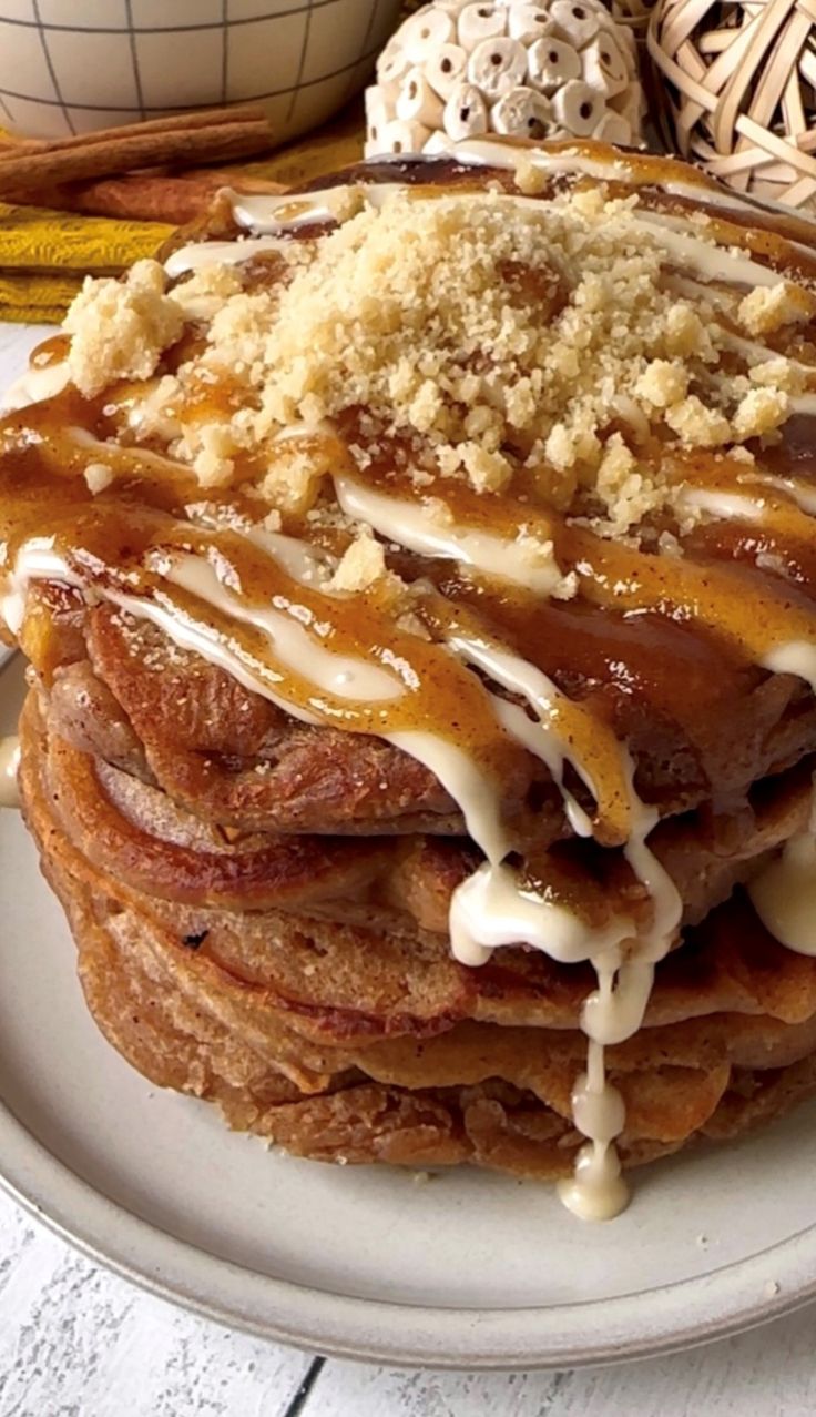 a stack of pancakes covered in icing on top of a white plate