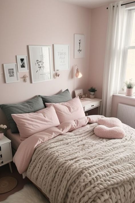 a bed with pink sheets and pillows in a small room next to a window that has pictures on the wall