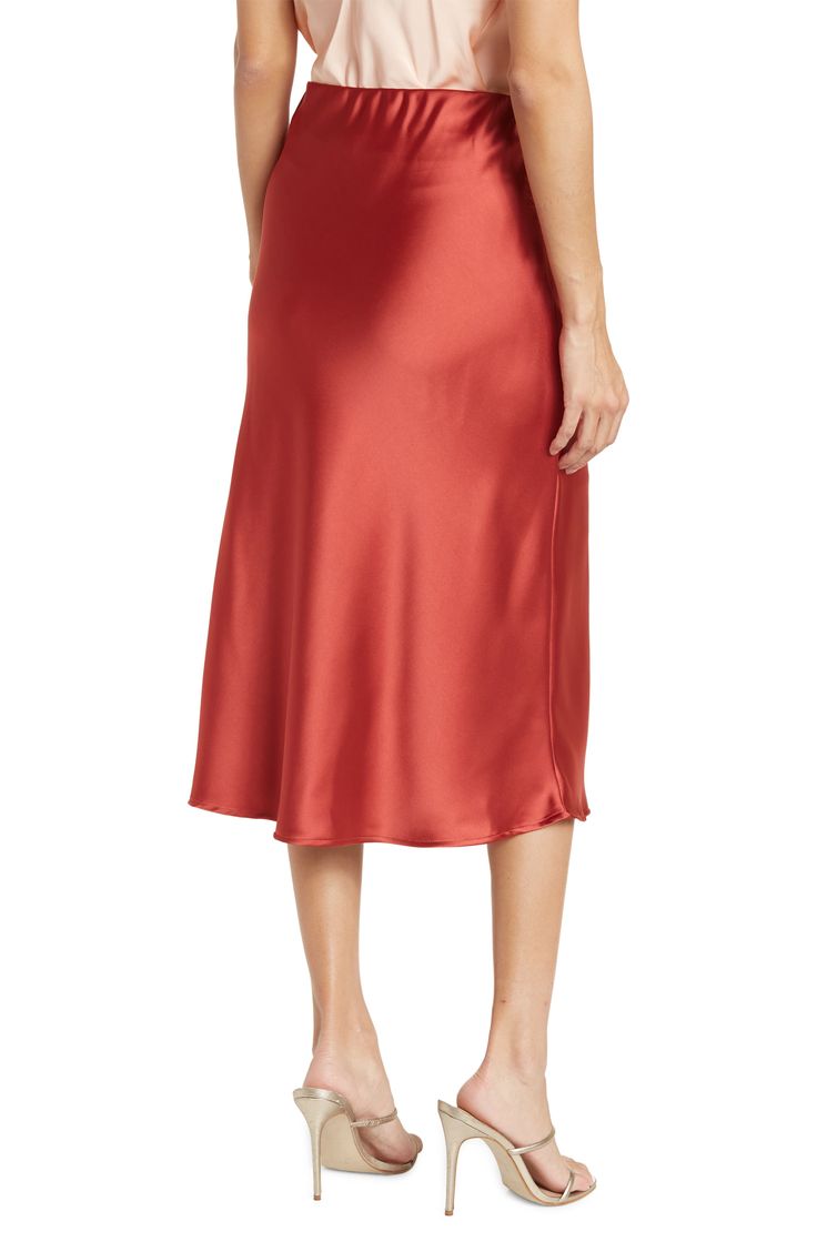 Elevate your wardrobe with this pull-on bias satin midi skirt for elegant, feminine style. 31" length (size S) Elasticized waist Pull-on style Satin construction 97% polyester, 3% spandex Machine wash cold, line dry Made in USA Model’s stats for sizing: 5’10” height, 34” bust, 27” waist, 35” hips. Model is wearing size S. Satin Midi Bottoms For Evening, Evening Satin Midi Bottoms, Silk Midi Skirt With Bias Cut, Silk Bias Cut Midi Skirt, Formal Knee-length Satin Skirt, Formal Satin Knee-length Skirt, Elegant Satin Midi-length Bottoms, Elegant Satin Midi Bottoms, Formal Satin Midi Skirt