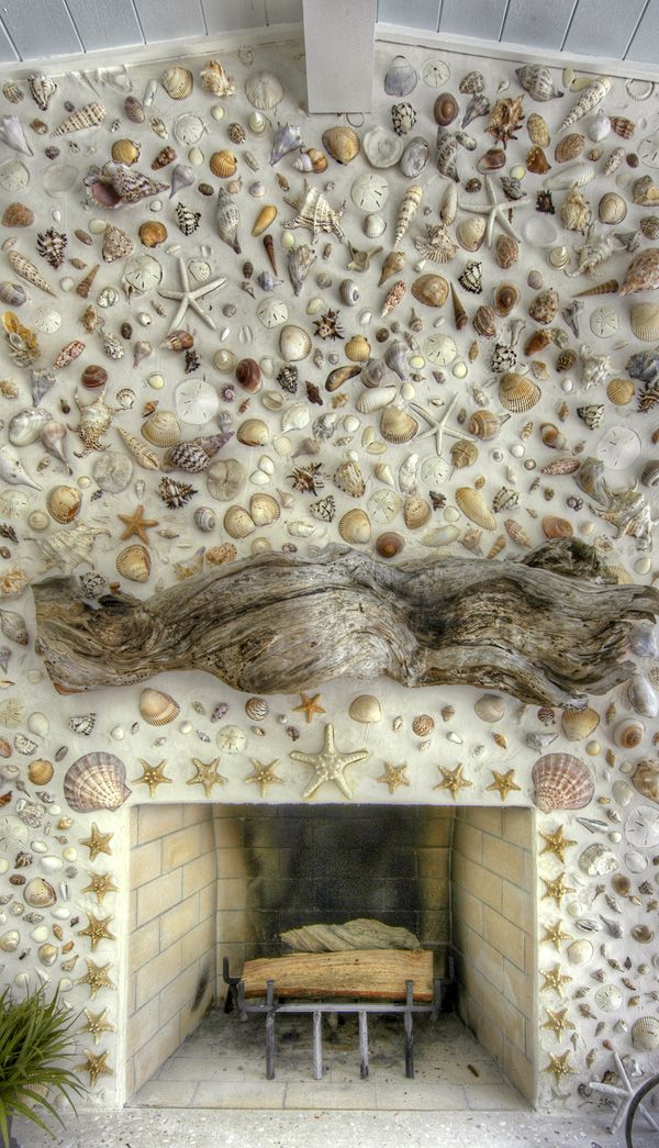 the fireplace is decorated with shells and seashells