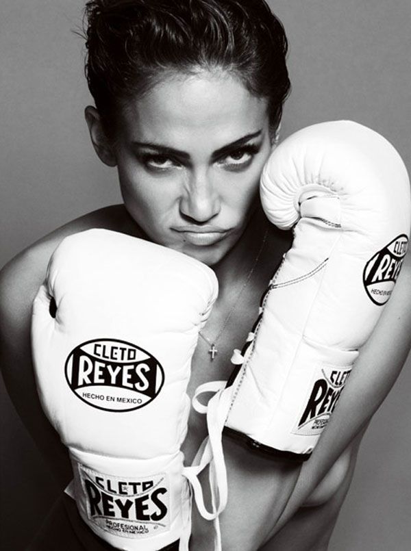 a woman wearing boxing gloves posing for a photo