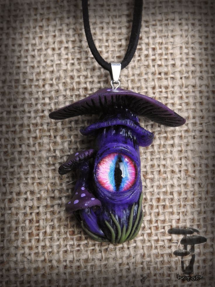 a purple necklace with an evil eye on it