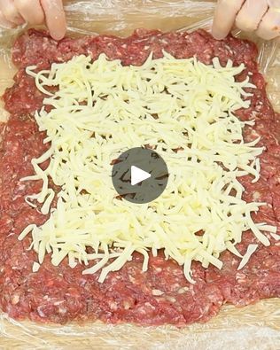 someone is making a pizza with cheese and ground meat on it in the process of being made