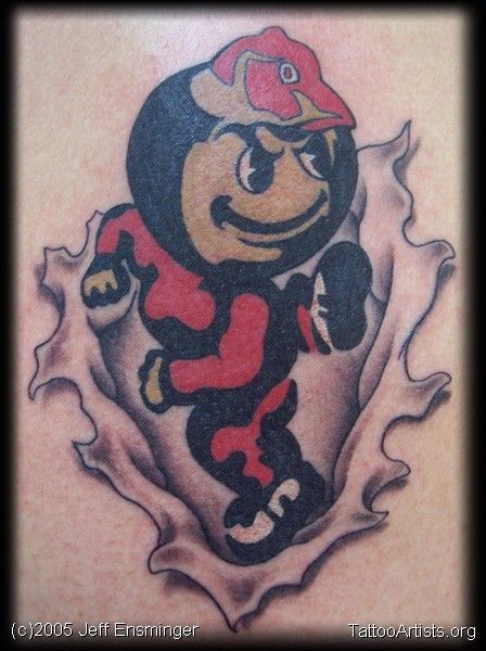 a baseball player tattoo on the back of a man's shoulder, with an image of a bear holding a bat