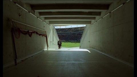 an empty tunnel with graffiti on the walls and grass in the backgrouds