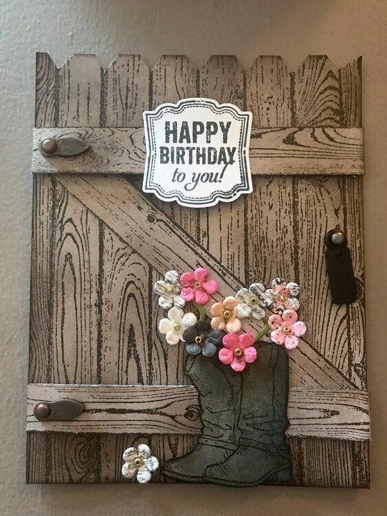 a birthday card with flowers in a cowboy boot on a wooden background that says happy birthday to you