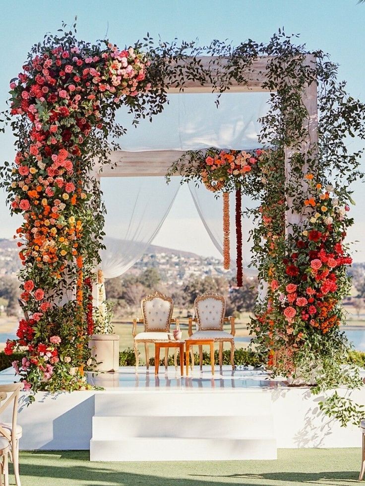 an outdoor wedding set up with flowers and chairs