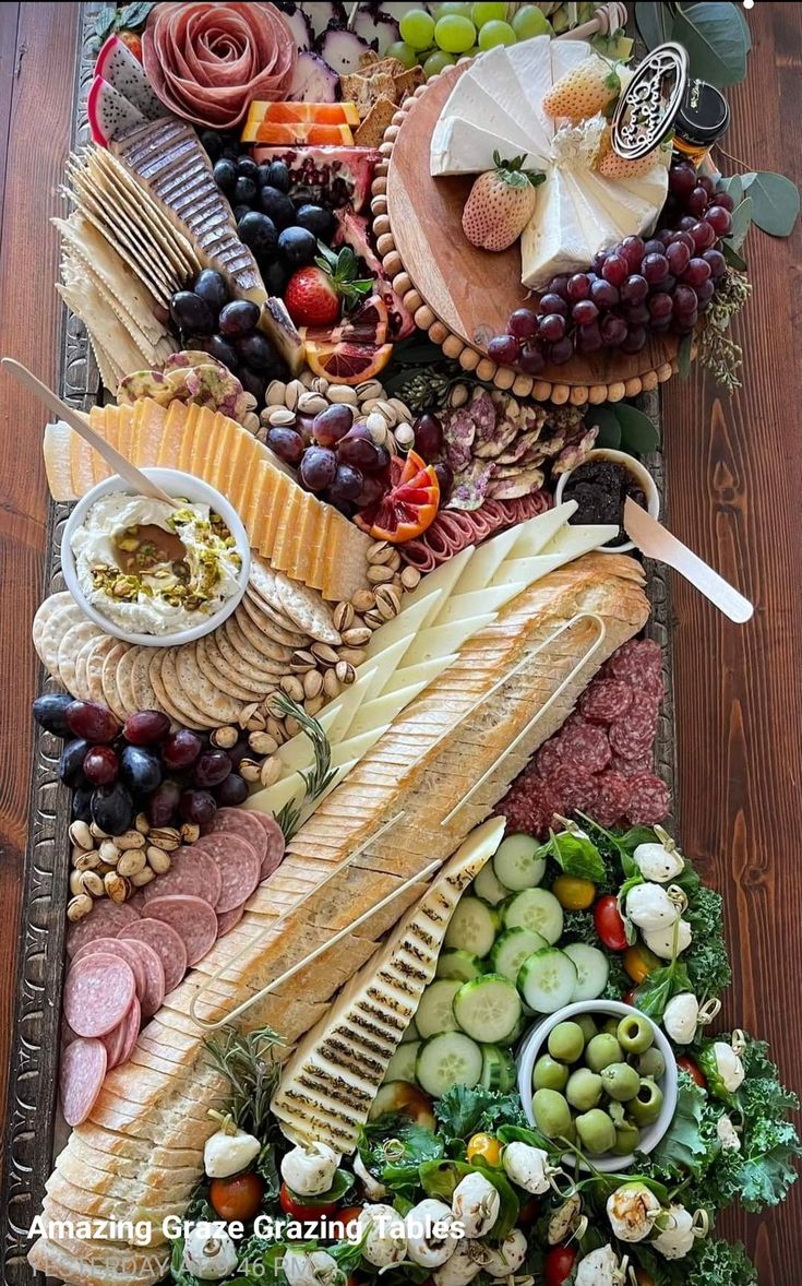 a platter filled with meats, cheeses, and other foods on top of a wooden table