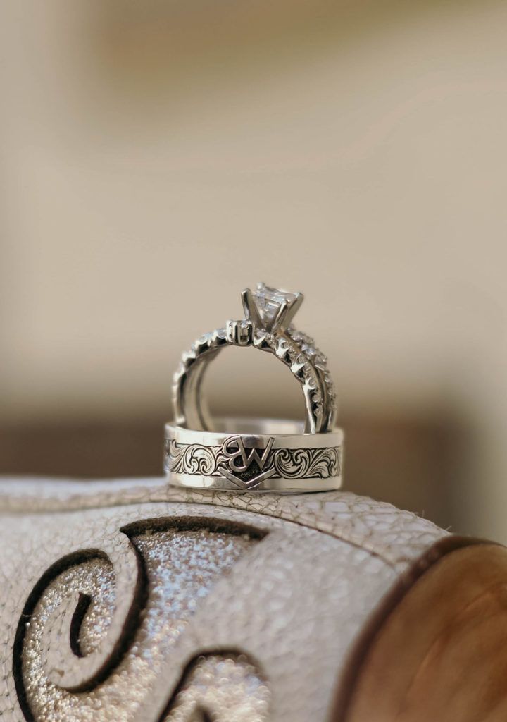 two wedding rings sitting on top of each other