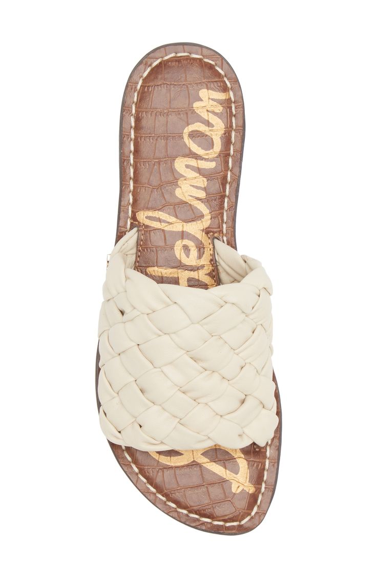 A cushioned footbed gives sweet underfoot comfort when you wear this chic slide sandal topped with woven leather straps. Flat sole Cushioned insole Leather upper/synthetic lining and sole Imported Comfortable Flat Slides With Woven Sole, Beige Leather Sandals With Woven Sole, Beige Woven Leather Sandals With Flat Heel, Woven Leather Slides For Spring, Spring Slides With Woven Leather, Beige Synthetic Slides With Cushioned Footbed, Comfortable White Sandals With Woven Sole, Beige Woven Leather Sandals With Round Toe, Casual Sandals With Woven Leather And Adjustable Fit