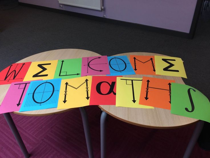 a welcome home sign made out of colorful sticky notes on a table in an office