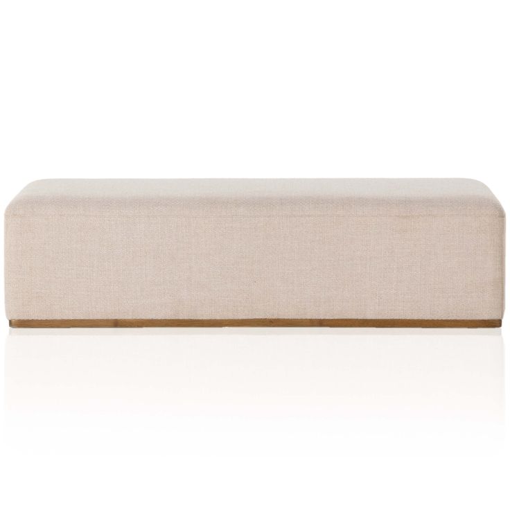 an upholstered bench with a wooden frame and fabric seat pad, on a white background