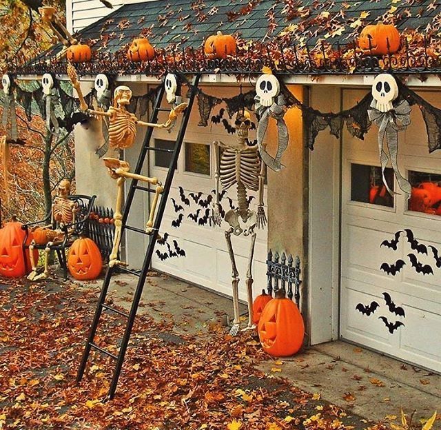 a house decorated for halloween with skeletons and pumpkins