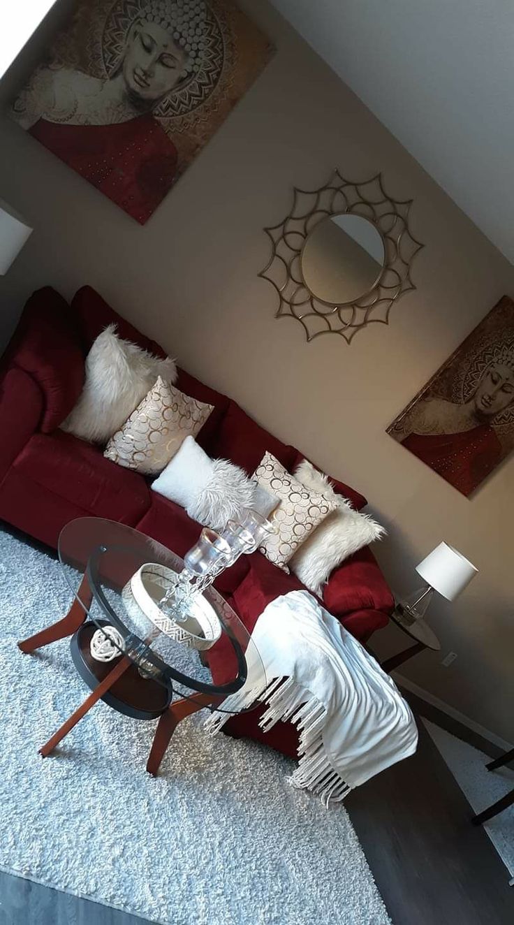 a living room with red couches and white rugs on top of the floor