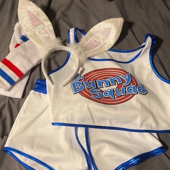 two bunny ears are on top of a white shirt and blue shorts with the words bunny squad printed on it