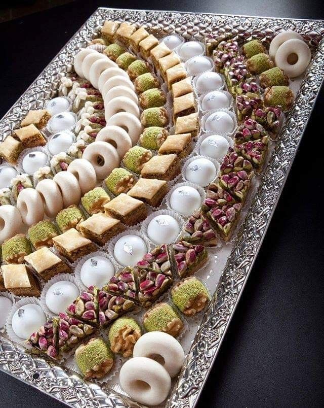 a platter filled with lots of different types of food on top of a table