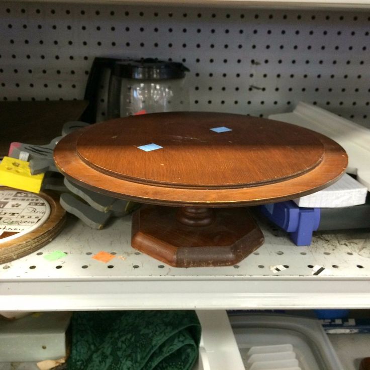 a wooden object sitting on top of a shelf