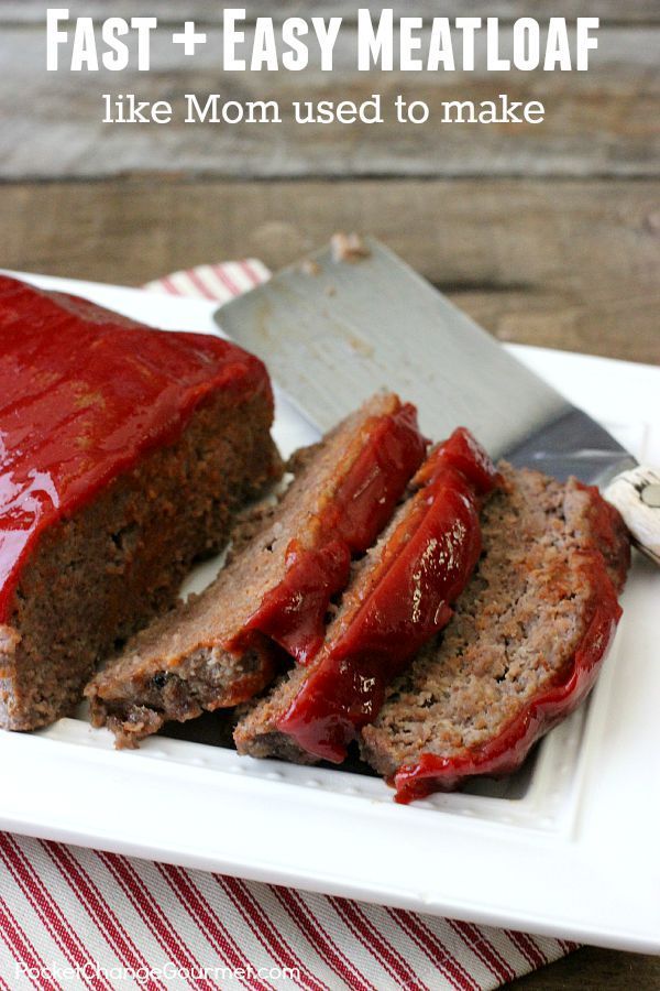 meatloaf with ketchup on a white plate