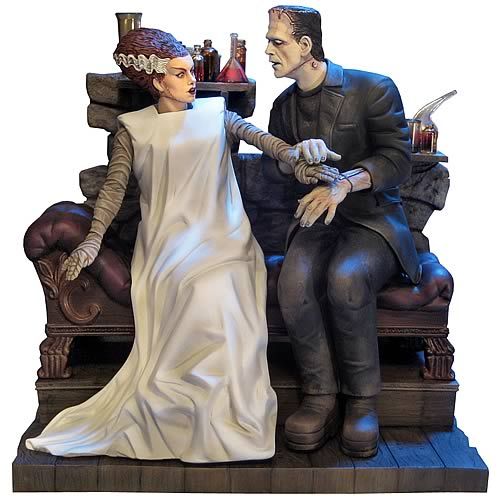 a statue of a man and woman sitting on a couch