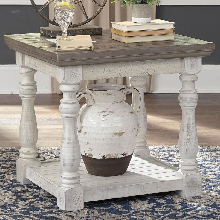 a table with a vase on top of it in front of a clock and rug