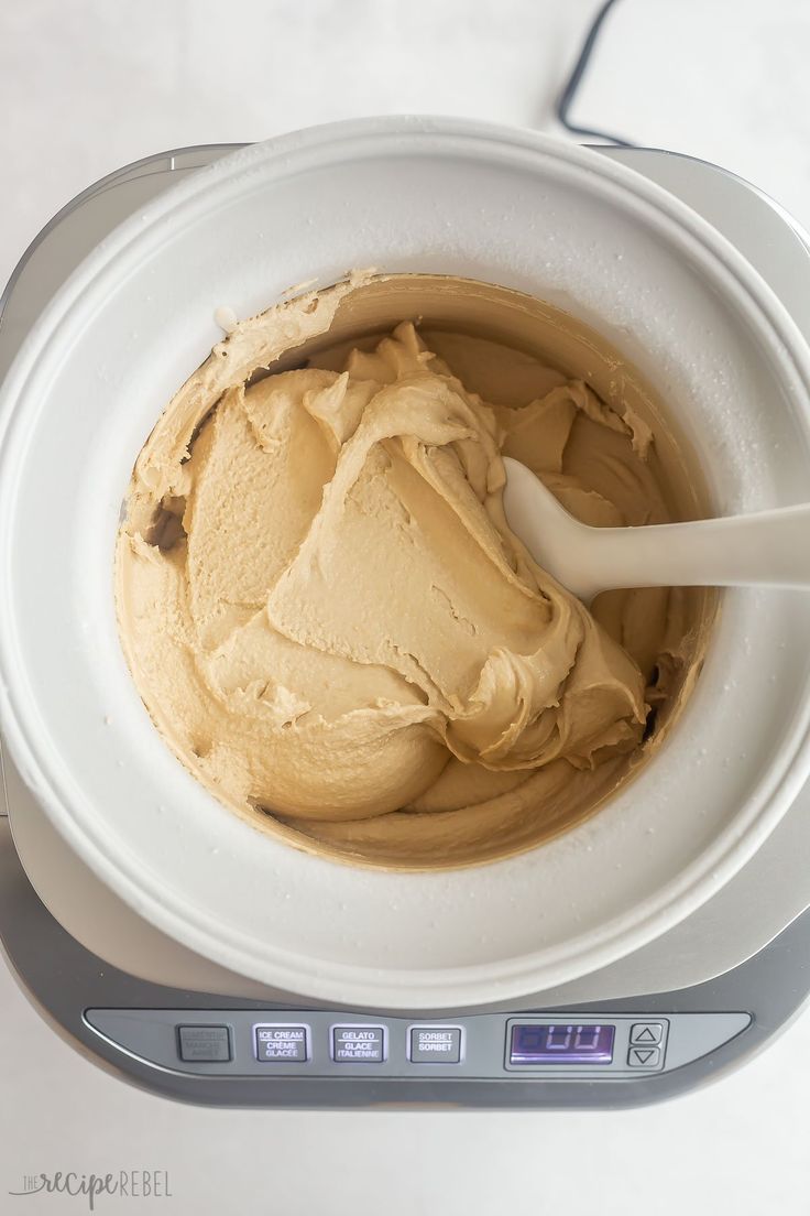 a white bowl filled with peanut butter on top of a scale