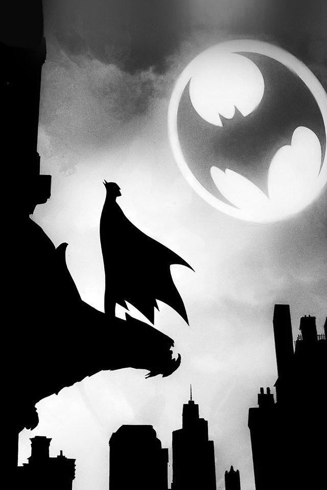 black and white photo of batman flying in the sky with cityscape behind it