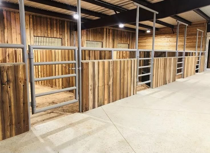 the inside of a building with wooden walls and ladders on each side of it