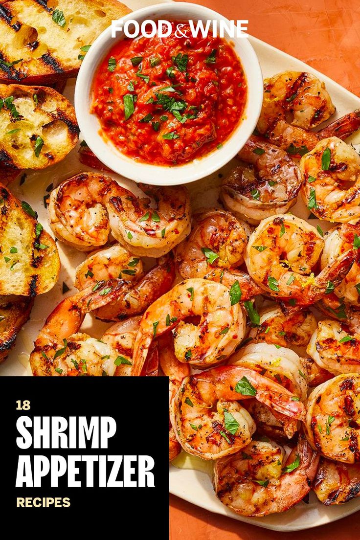 the shrimp appetizer is served with bread and tomato sauce, along with garlic bread