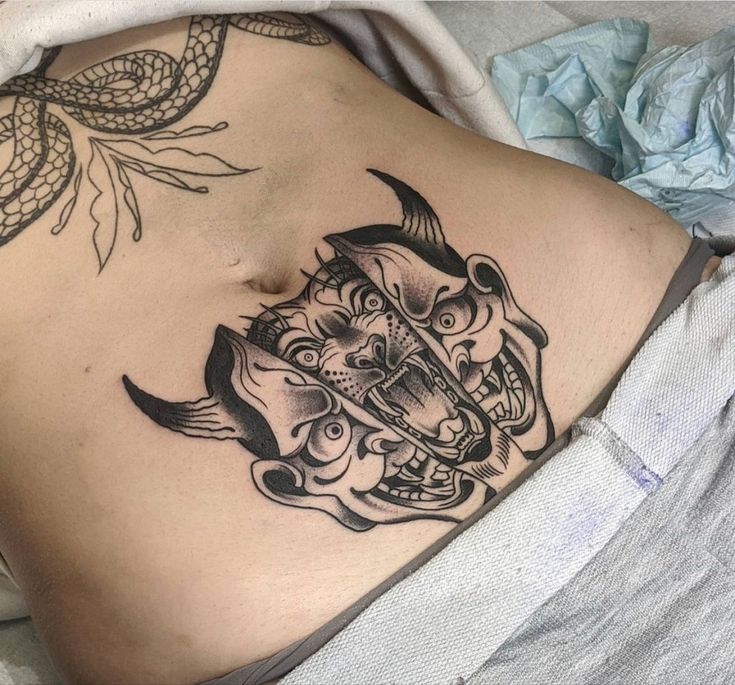 a woman with a tattoo on her stomach