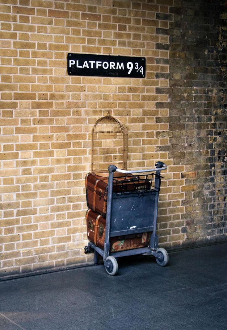 suitcases are stacked on top of each other in front of a brick wall