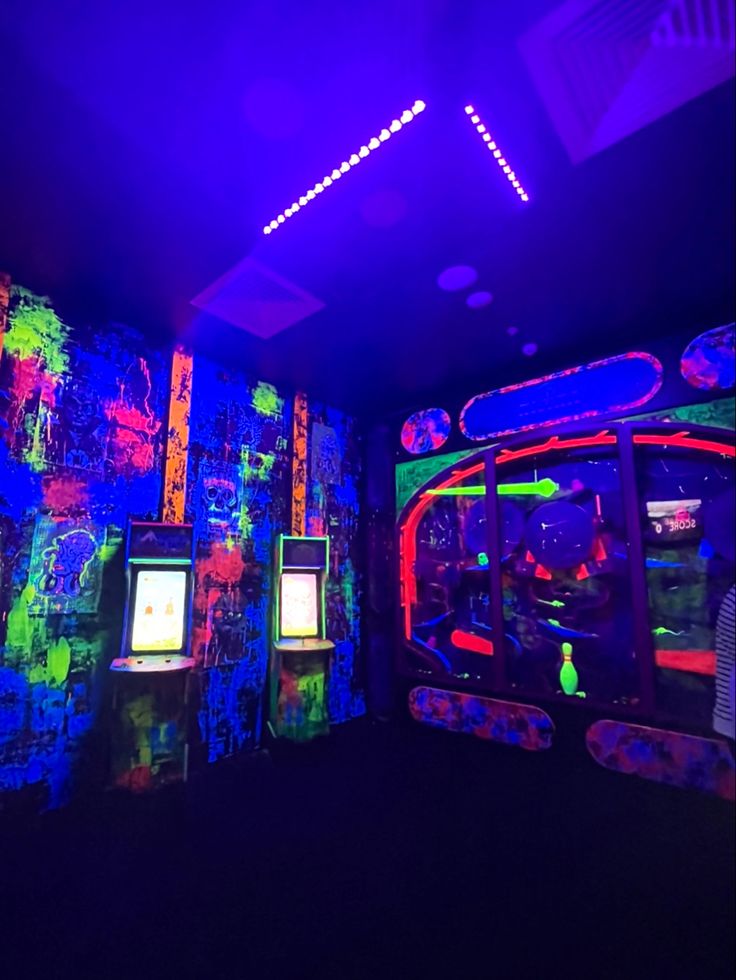 brightly lit room with arcade machines and neon lights