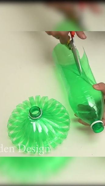 someone is cutting plastic with scissors on the table next to a green bottle that has something in it