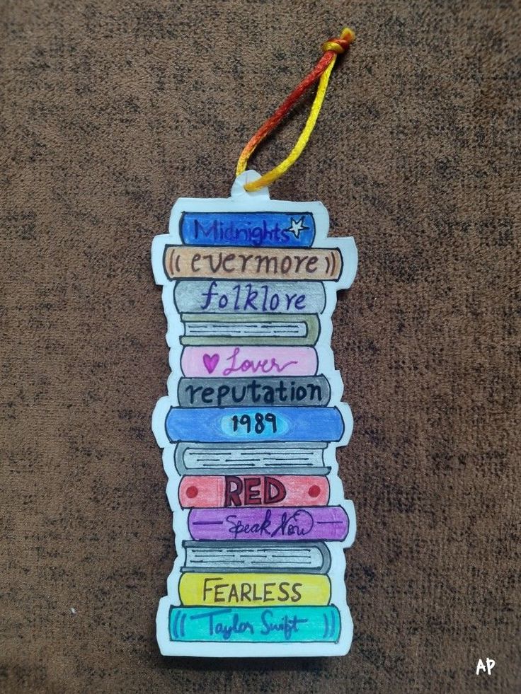 a bookmark hanging on the ground with books written in different languages and colors,