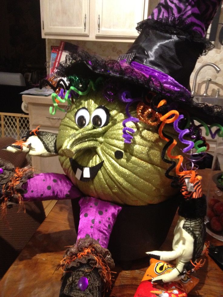 a halloween decoration in the shape of a pumpkin wearing a witch's hat