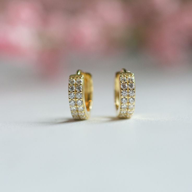 Made of Sterling Silver 14K Gold or Rhodium plating Nickel-free & Hypoallergenic Highest grade CZ for an authentic diamond look! Dimensions: Inner Diameter: 7mm Outer Diameter: 10mm Thickness: 3mm Sold as a pair Classic Gold Huggie Earrings With Brilliant Cut, Classic Yellow Gold Huggie Earrings With Cubic Zirconia, Classic Yellow Gold Cubic Zirconia Huggie Earrings, Gold Huggie Earrings With Pave Setting For Wedding, Gold Cubic Zirconia Huggie Earrings Round Cut, Gold Plated Huggie Earrings With Prong Setting, Gold Diamond Huggie Earrings With Prong Setting, Gold Huggie Earrings With Pave Setting, Classic Gold Plated Huggie Earrings With Diamond Accents