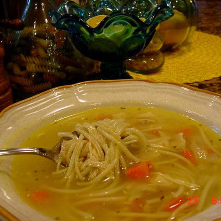 a bowl of soup with noodles and carrots