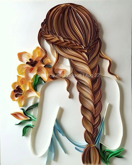 a paper sculpture of a woman with long hair and flowers in her hair is shown