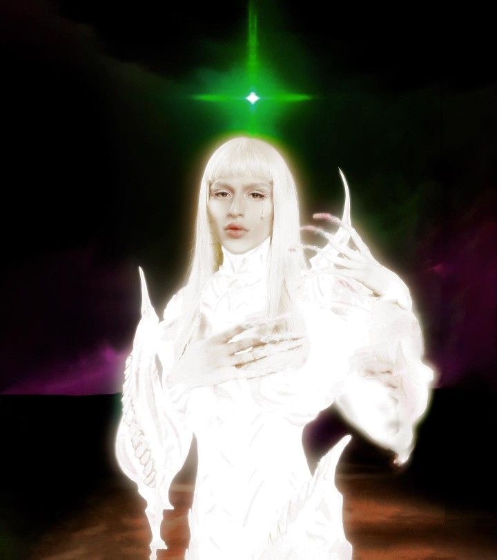 a woman with white hair standing in front of a green light