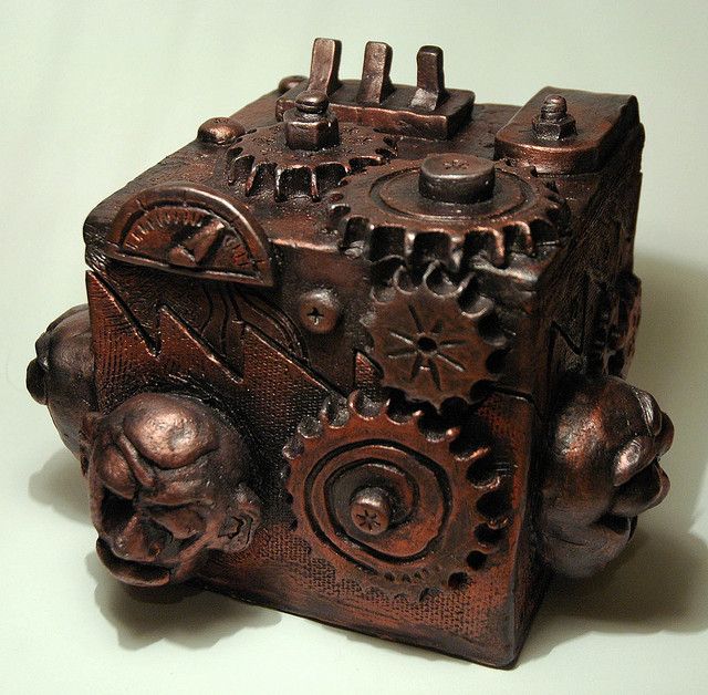 an intricately carved wooden box with gears on it