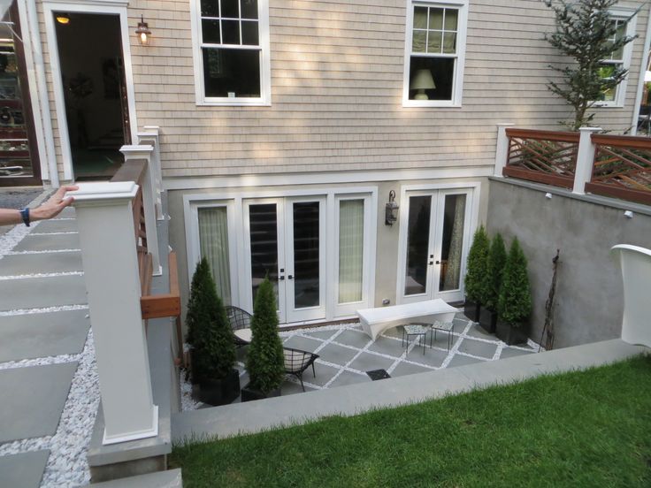 an outside view of a house with lawn and patio furniture