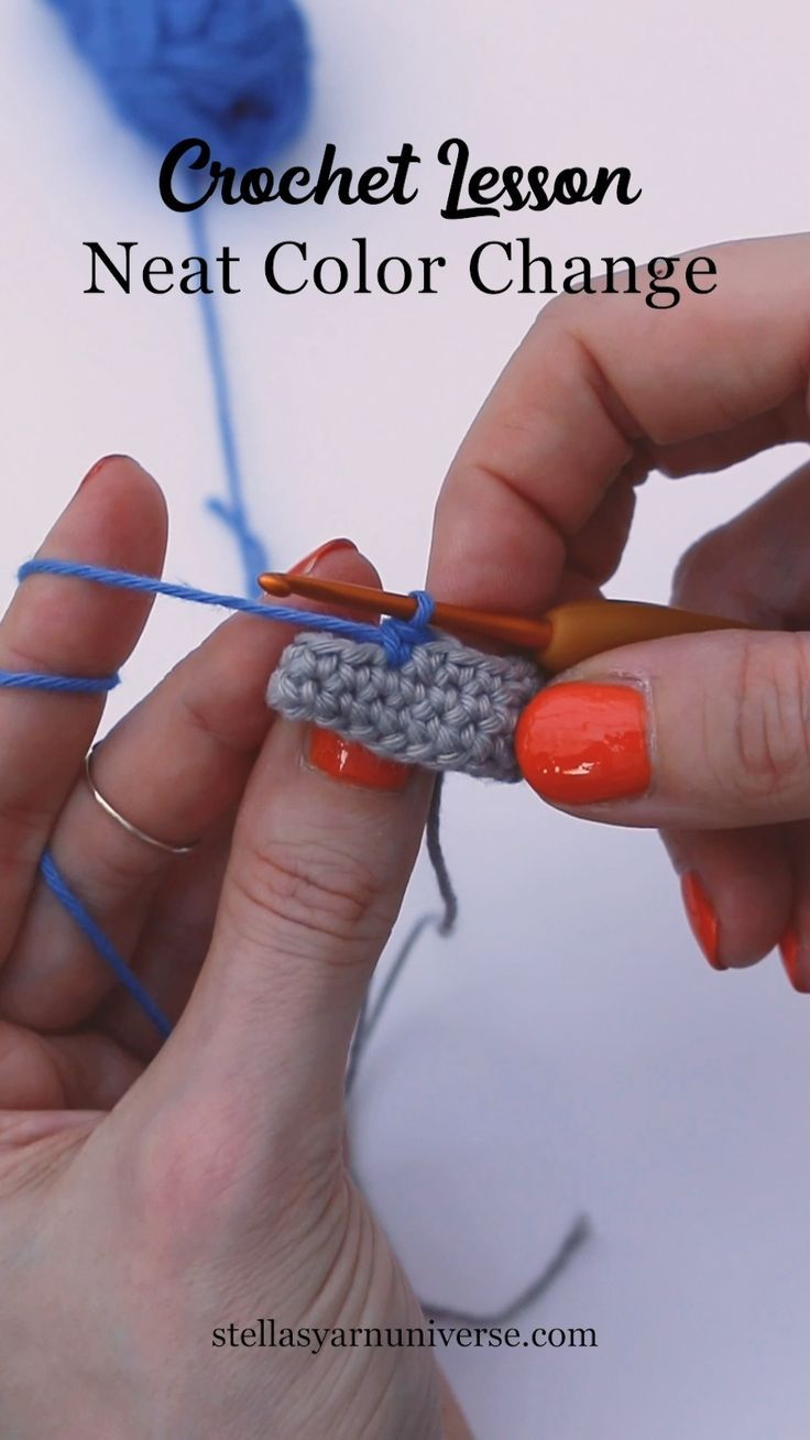 someone crocheting the next color change on their fingernails and using yarn