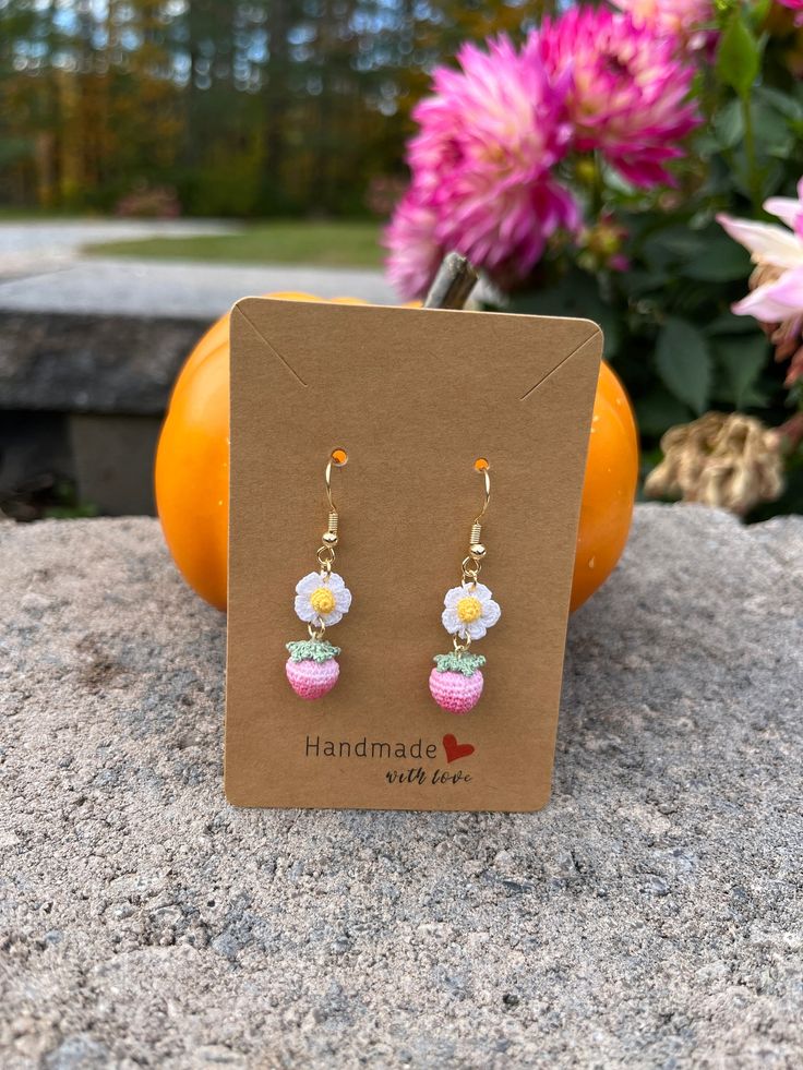 These charming Crochet Pink Strawberry Earrings are a perfect festive accessory or thoughtful gift for her! Expertly handcrafted using intricate microcrochet techniques, these dangle earrings feature delicate donut designs that add a playful, unique touch. Each pair is crafted with love and care, using high-quality materials and finished with 14k gold-plated hooks for a touch of elegance. Lightweight and comfortable to wear, they make a standout piece of handmade jewelry that's perfect for the holiday season or year-round fun. Whether you're treating yourself or surprising a loved one, these kiwi earrings are a whimsical, stylish addition to any collection! Features: Handmade with love using microcrochet techniques 14k gold-plated hooks for a luxurious touch Lightweight and comfortable for Handmade Dainty Beaded Drop Earrings, Cute Beaded Earrings For Gift, Cute Beaded Earrings For Gifts, Pink Crochet Jewelry Gift, Handmade Dangle Earrings As Gift, Dainty Handmade Flower Earrings As Gift For Her, Handmade Beaded Dangle Earrings Gift, Handmade Beaded Dangle Earrings For Gift, Handmade Dangle Beaded Earrings Gift