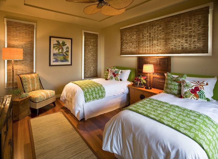 two beds in a bedroom with green and white bedding