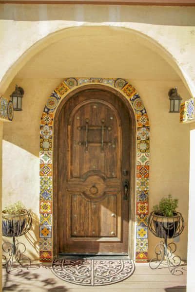 a wooden door sitting next to two planters