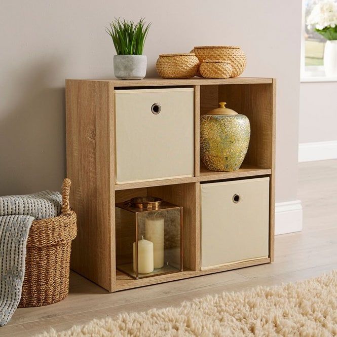 a shelf with baskets and vases on top of it